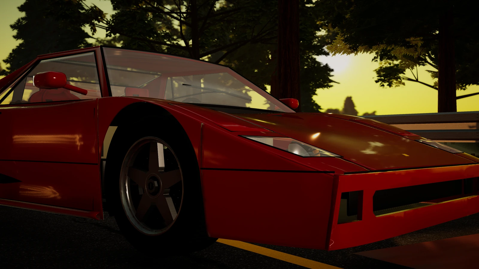 Close on the F40's front wheel and nose, the low sun burning through the pines.