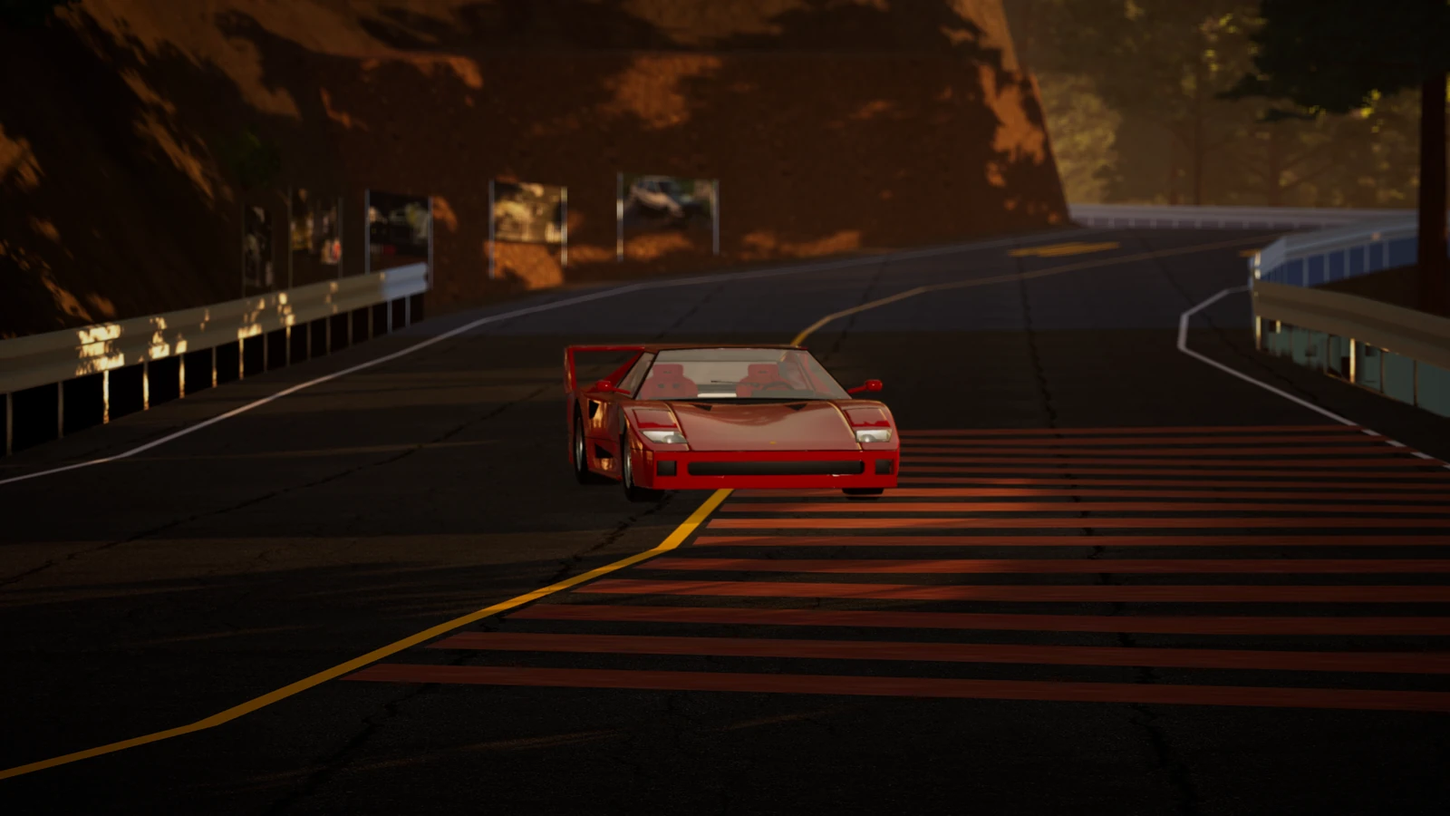 The F40 on the red and white hairpin markings of a mountain pass at golden hour.